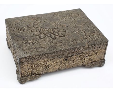 A late 19th century Japanese antimony casket, Meiji period:, of rectangular outline, with all over low relief floral and foli