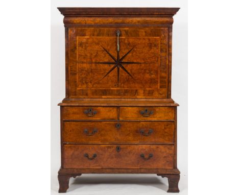 An early 18th Century burr walnut veneer and feather banded escritoire:, with a moulded cornice and cushion frieze drawer inl