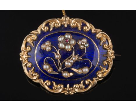 A Victorian gold, blue enamel and seed pearl oval memorial brooch:, with central floral 'forget me not' design, the reverse w