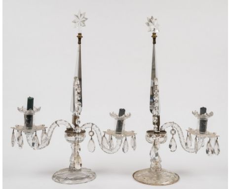 A pair of Regency-style cut glass two-branch lustre candelabra: of faceted design, each with central tapering triangular colu