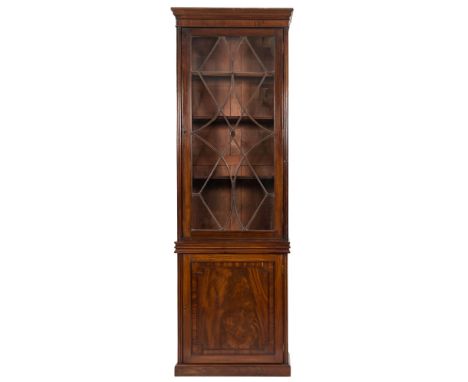 A 19th Century mahogany upright bookcase:, the upper part with a moulded cornice, enclosed by an astragal glazed panel door b