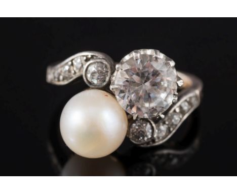 A diamond, pearl or cultured pearl and gem-set cross over ring: with diamond-set shoulder, ring size K. 