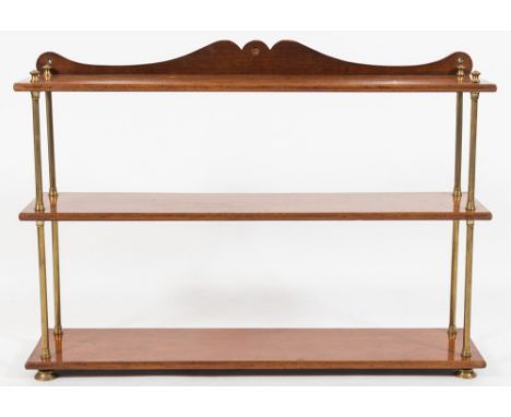 A 19th Century mahogany three tier campaign bookcase:, with detachable shelves and brass column uprights, having a shaped led