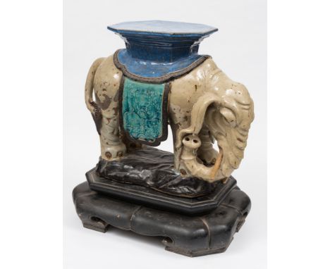 A pair of large Chinese stoneware elephant-form garden seats: each caparisoned elephant with trunk held to one side and suppo