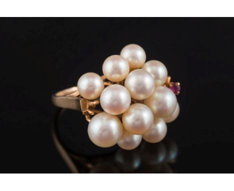 A cultured pearl and ruby-set cluster ring:, with 12 cultured pearls of various size and a small, four-claw set ruby, ring si