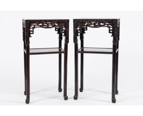 A pair of Chinese carved hardwood rectangular jardiniere stands:, with rouge variegated marble inset tops and foliate scroll 