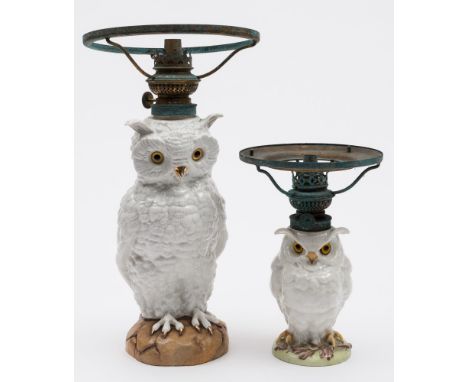 A French porcelain 'owl' table lamp and one similar: both with glass eyes and on mound bases, the smaller with impressed nume