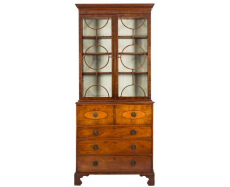 A George IV mahogany and inlaid secretaire bookcase:, the upper part with a moulded dentil cornice, fitted with adjustable sh