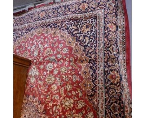 A Kashan style carpet, with central floral medallion, on a red ground, contained by floral borders, 280 x 200cm 