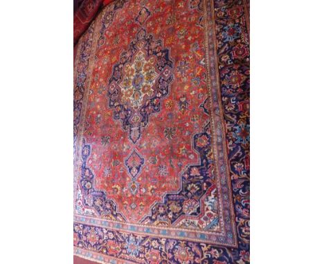 A fine central Persian Isfahan carpet, double pendent medallion with repeating spandrels on a rouge field within stylised sap