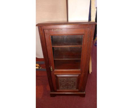 An Art Nouveau mahogany side cabinet, with part glazed and part carved door, raised on bracket feet, H.102 W.52 D.37cm 