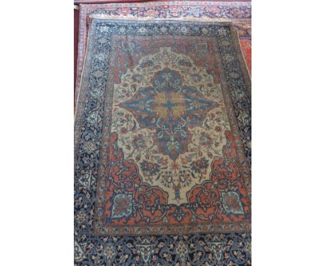 An antique Kashan carpet, with central floral medallion, contained by floral borders, 220 x 140cm 