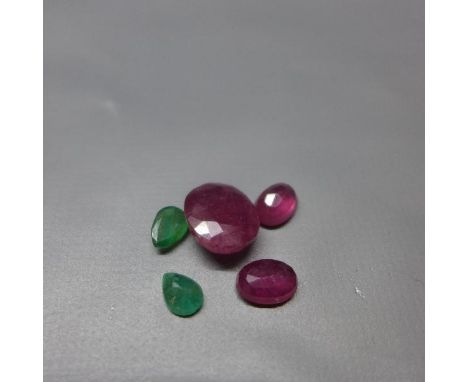 An oval cut loose ruby, approx. 4ct, together with two oval cut loose rubies, approx 1.5ct each, and two pear cut loose emera