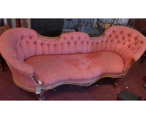 A Victorian walnut sofa, with button back damask upholstery, C-scroll decorated frame, raised on cabriole legs and castors, H