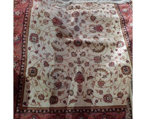 A Kashan style carpet, with central floral medallion, on a beige ground, contained by floral borders, 230 x 160cm 