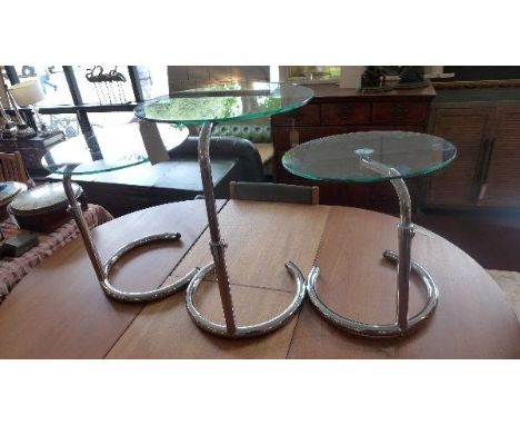 A set of three contemporary lamp tables, with glass tops and adjustable chrome bases 