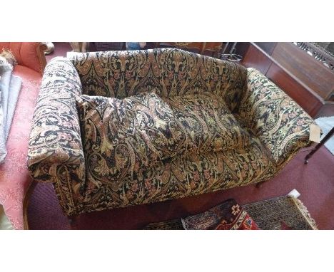 A 20th century camel back sofa, with paisley upholstery, raised on cabriole legs 