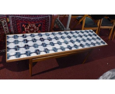 A mid 20th century 'Standart LTD' teak coffee table with tile top, raised on tapered legs, with label, H.46 W.140 D.43cm 