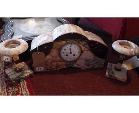 An Art Deco marble and brass mounted mantel clock garniture, with Arabic enamel dial, drum movement, strikes a bell to hour a