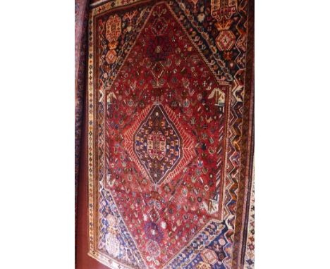 An extrmeley fine South West Persian Qashqai carpet, central diamond medallion on a terracotta field with repeating petal and