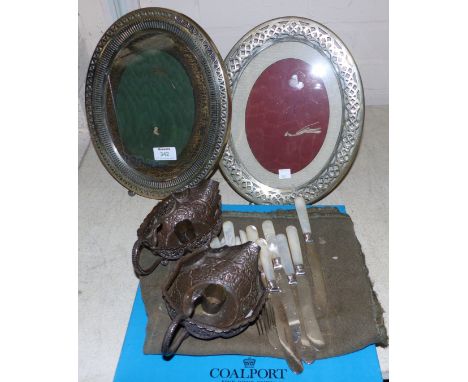 A pair of EPNS oval easel frames, 12"; a pair of 19th century Indian silver on copper chambersticks; mother-of-pearl handled 