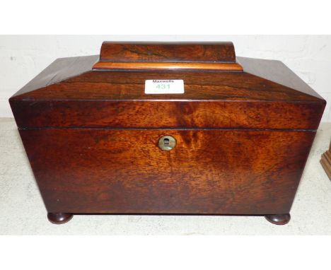 An early 19th century rosewood sarcophagus shaped tea caddy with fitted interior and glass mixing bowl