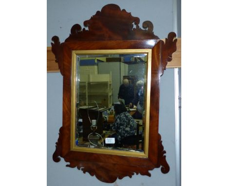 A rectangular wall mirror in Chippendale style pierced parcel gilt and fretwork frame