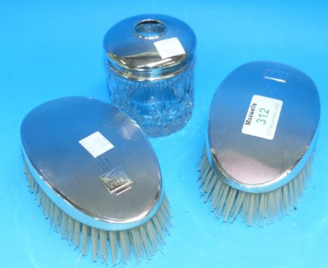 A pair of gent's engine turned silver back hair brushes; a silver top hair tidy