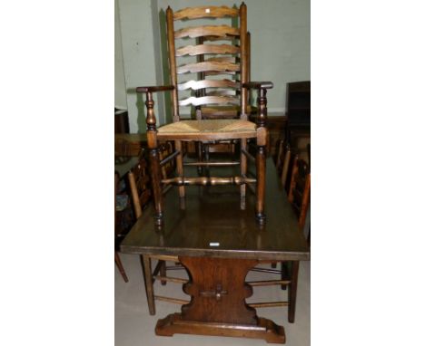 A reproduction oak dining suite by Bannister Brothers, Bollington comprising rectangular refectory table and 8 (4 + 2) ladder