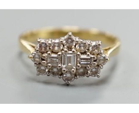 A modern 18ct gold and diamond cluster dress ring, size P, gross weight 4.2 grams, set with round and baguette cut stones.