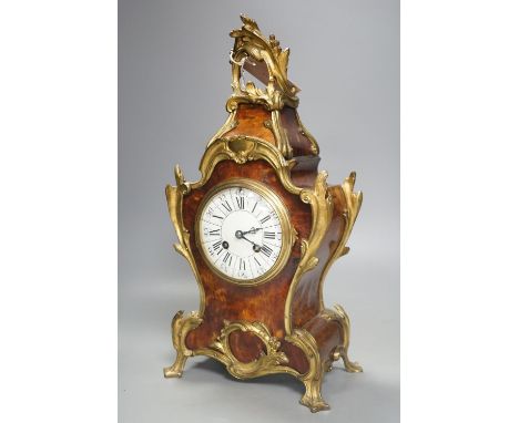 A 19th century French tortoiseshell and ormolu mounted mantel clock,40 cms high.
