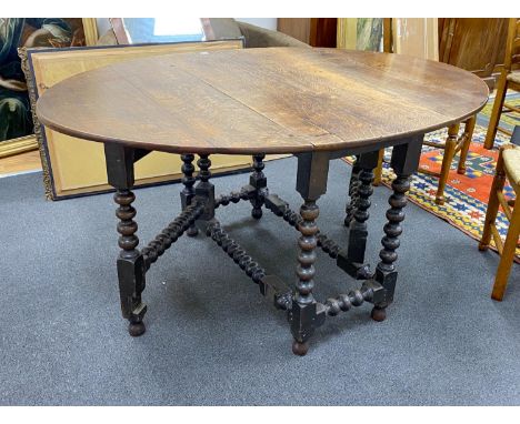 An early 19th century oak bobbin leg gateleg dining table, length 154cm extended, width 108cm, height 76cm