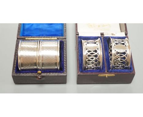 A cased pair of George V engine turned silver napkin rings, by Charles Horner, Chester, 1923 and an Edwardian cased pair of s