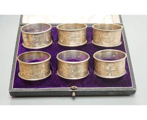 A cased set of six Edwardian engraved silver napkin rings, J &amp; R Griffin, Chester, 1902.