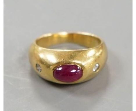 A yellow metal, cabochon ruby and two stone diamond chip set ring, size E/F, gross weight 6.6 grams.