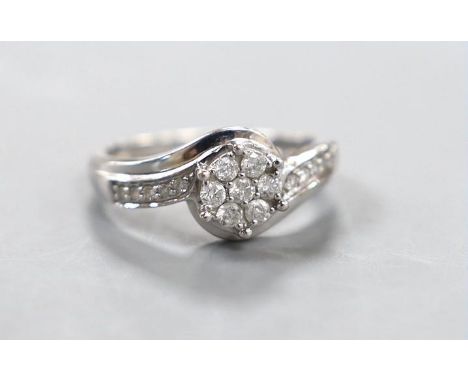 A modern 18kt white metal and diamond cluster set  ring, size P, gross weight 3.8 grams.