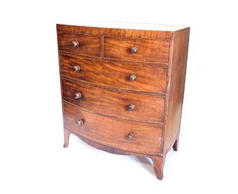 A Victorian mahogany bow front chest of drawers, with caddy top, above two short and three long drawers, each with turned woo
