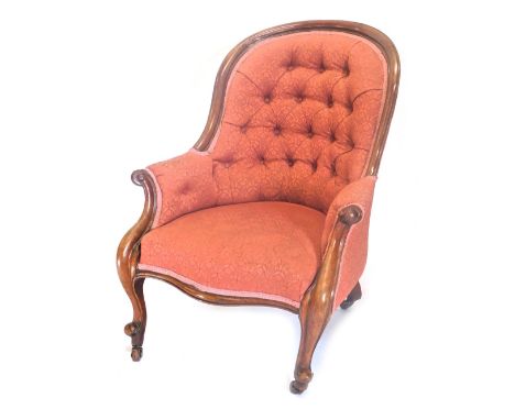 A Victorian mahogany show frame armchair, with a button padded back, arm rests and seat, in pink pattern fabric, with scroll 