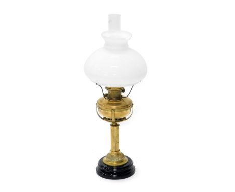 A late 19th/early 20thC brass oil lamp, with central column, ceramic base and opaque shade, 75cm high. (AF)