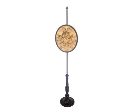 A late 19th/early 20thC mahogany pole screen, the oval banner with a machine woven tapestry, on a circular part fluted carved