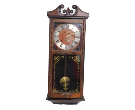 A walnut cased President thirty one day mantel clock, the Roman numeric dial fronted by a glazed door, 67cm high. 