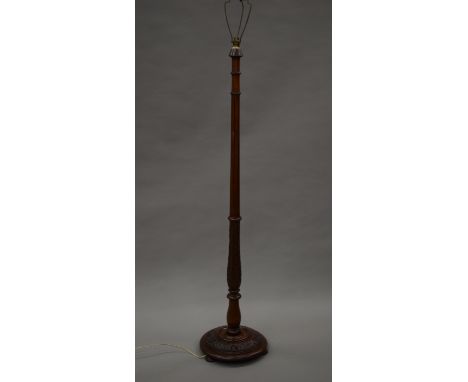 A carved mahogany standard lamp. 173 cm high overall.