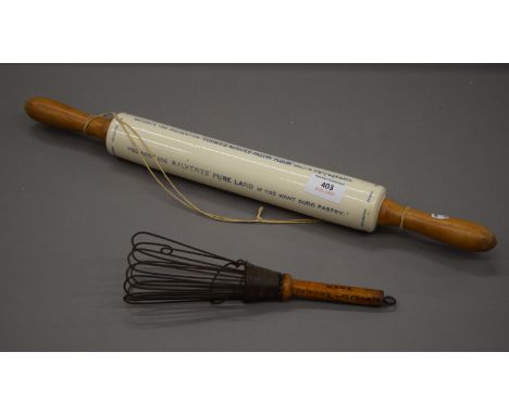 An advertising pottery rolling pin with four lines advert and a Bournville Cocoa whisk. The former 52 cm long.