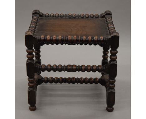 A Victorian oak bobbin twist stool. 49.5 cm wide.