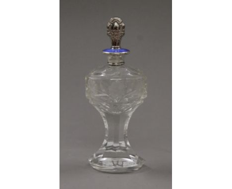 A sterling silver and enamel mounted cut glass scent bottle with silver plated stopper. 21 cm high.