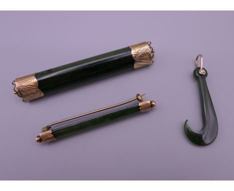 Two antique 9 ct gold and jade bar brooches (the larger 7.5 cm long, smaller brooch 5.75 cm long) and a 9 ct gold and jade Mo