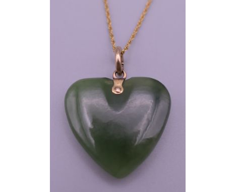 A jade pendant on a 9 ct gold chain. The pendant 2.5 cm high.