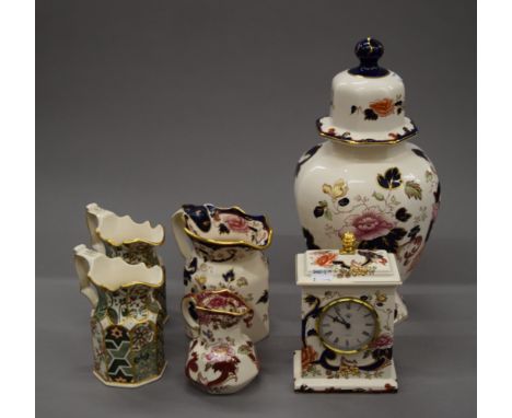 A quantity of Masons Ironstone porcelain, including jugs, a lidded vase and a mantle clock. The lidded vase 40 cm high.