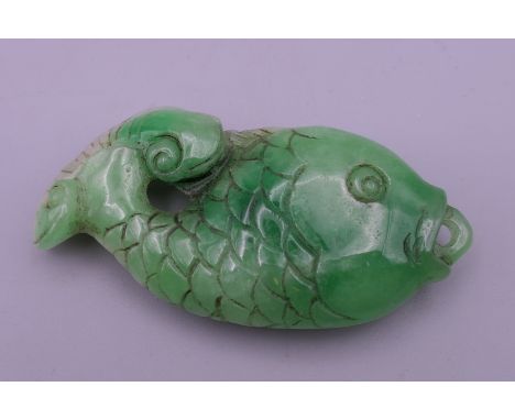 A Chinese carved jade pendant formed as a fish. 7.5 cm long.