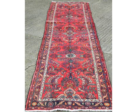 A red ground Hamadan runner. 388 x 86 cm.